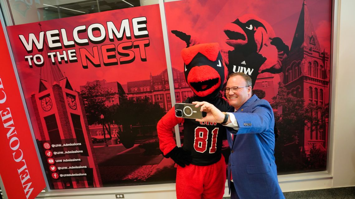 Red the Cardinal and President Dr. Thomas M. Evans take a selfie