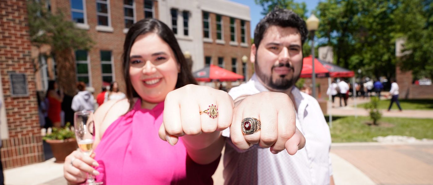 Two students show off their class rings