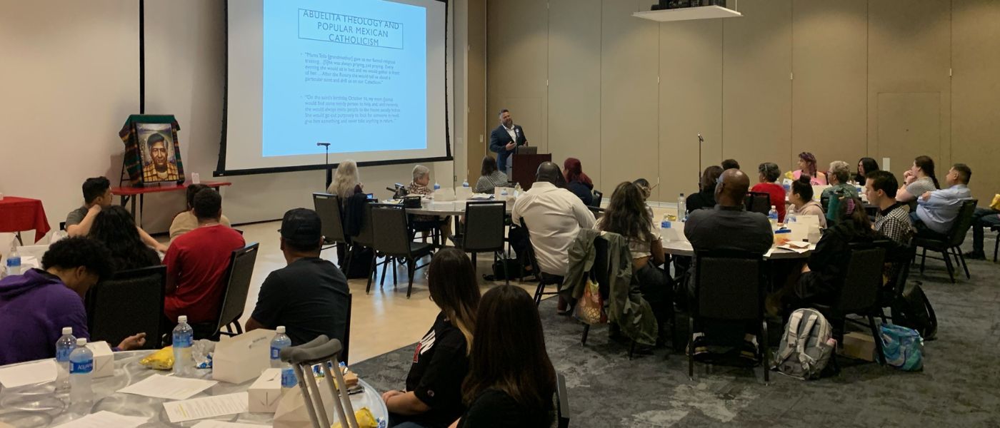 Dr. Robert Romero presenting to UIW community