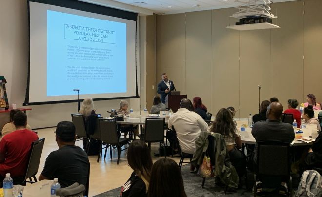 Dr. Robert Romero presenting to UIW community