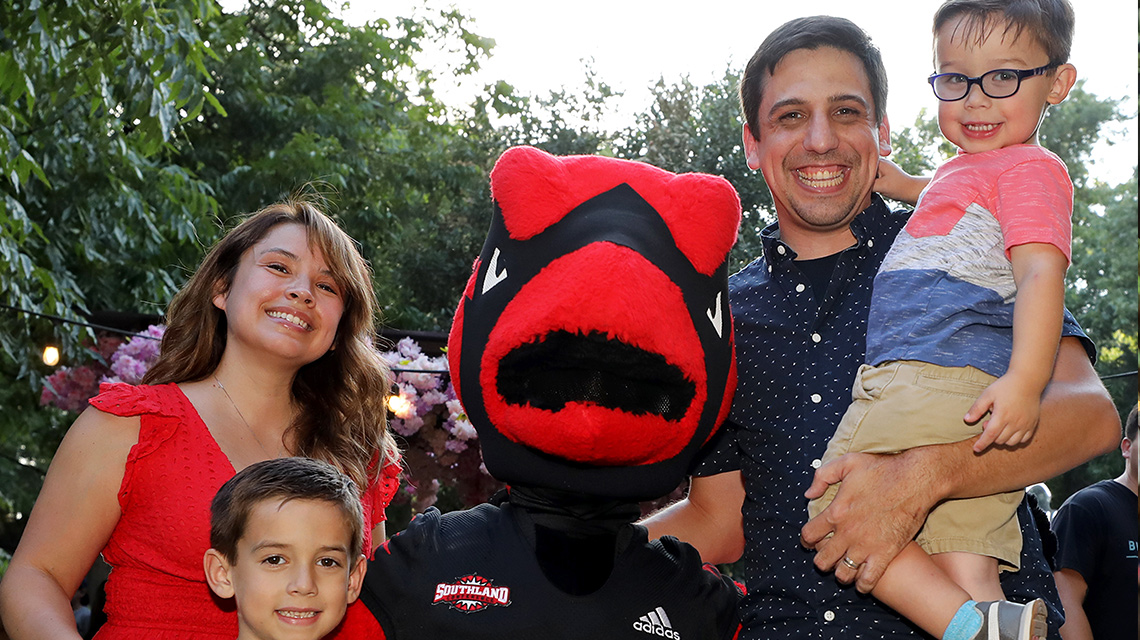 family with cardinal mascot