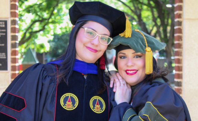 Silva sisters wearing regalia