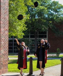 Silva sisters tossing their tams in the air