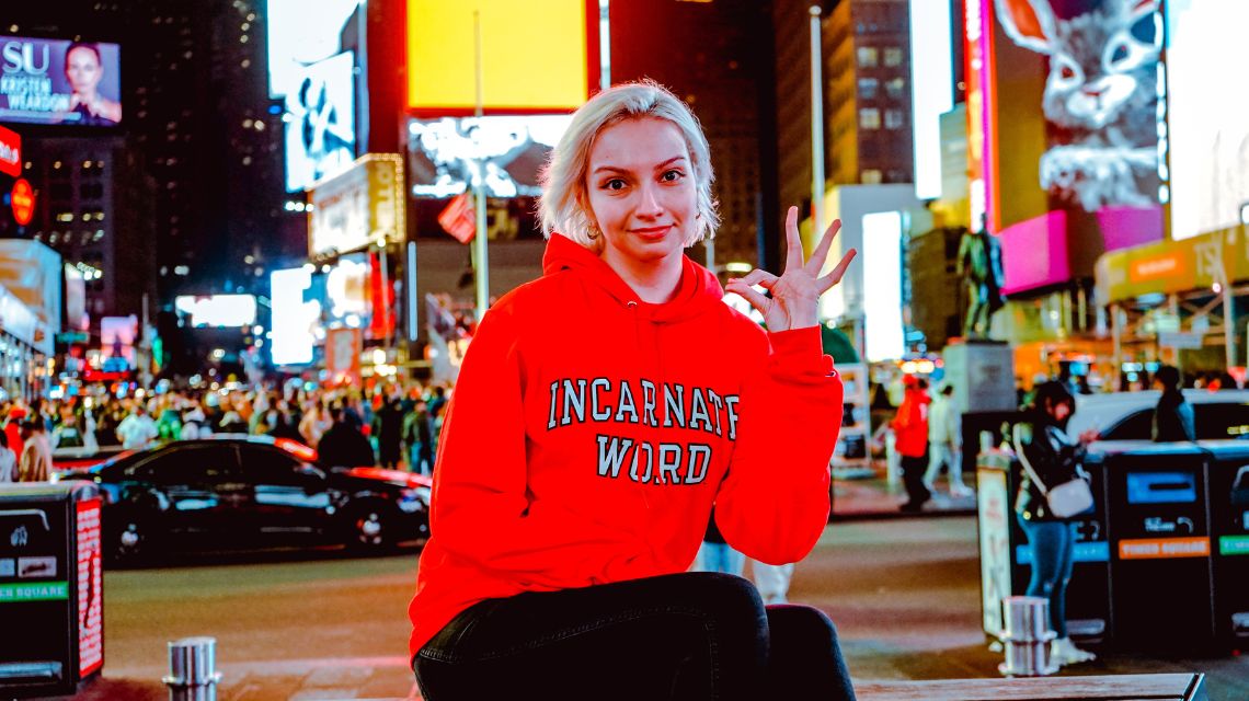 Sarah Cox in red Incarnate Word hoodie in Times Square