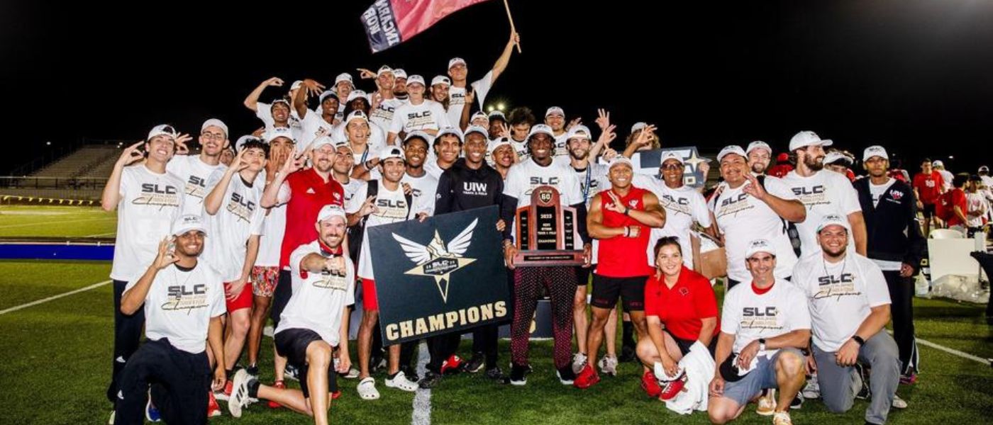 Men's track and field team with the trophy