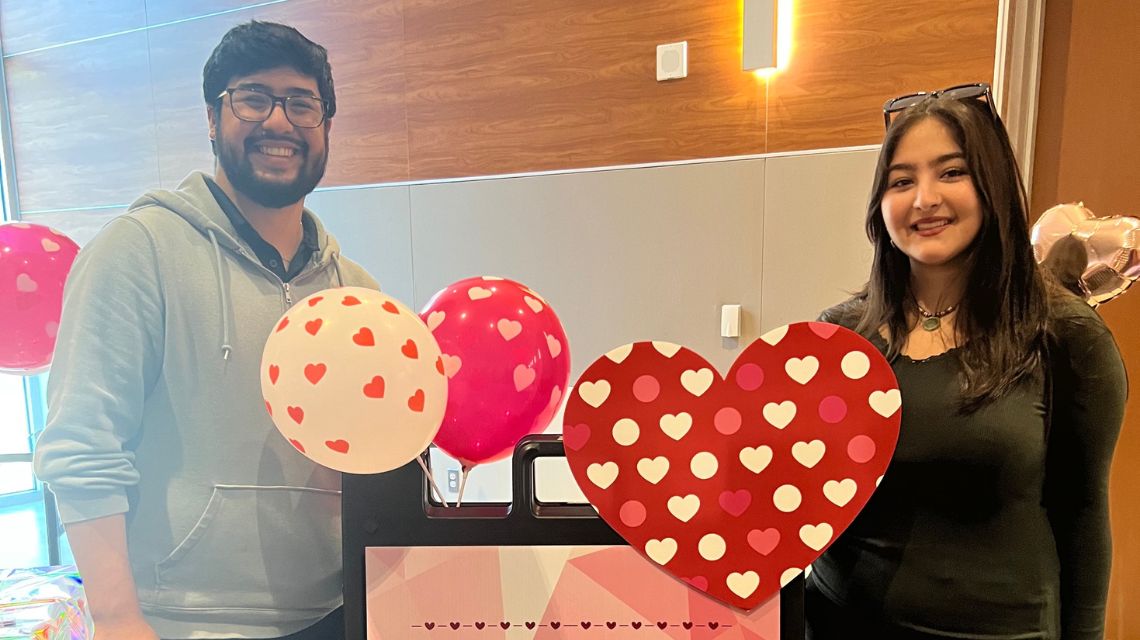 Two students smiling with balloons