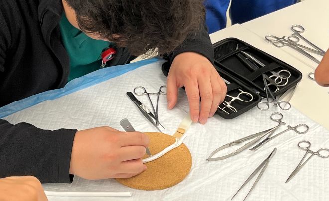 Student working with medical tools during the workshop