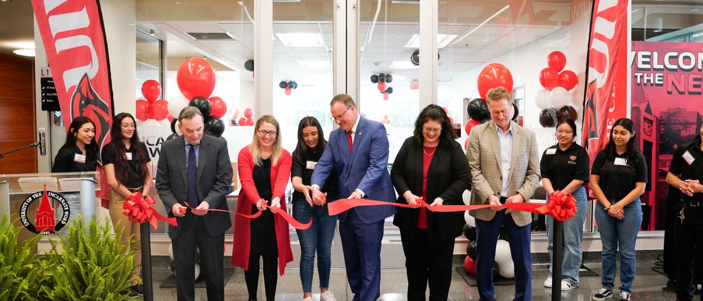 Six people cutting a ribbon