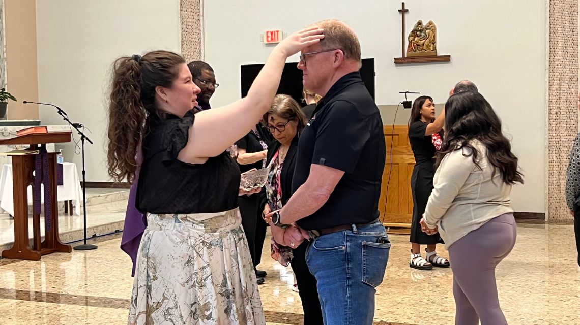 Man in black shirt receives ashes