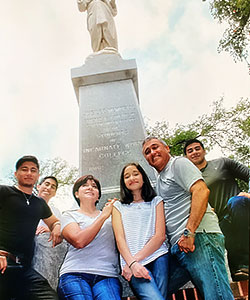 Zarate family in front of statue
