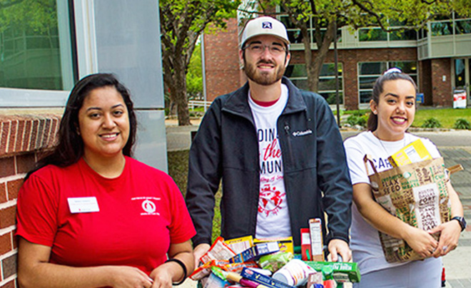 three students holding food