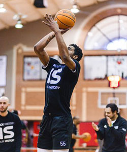Basketball player shooting ball into hoop