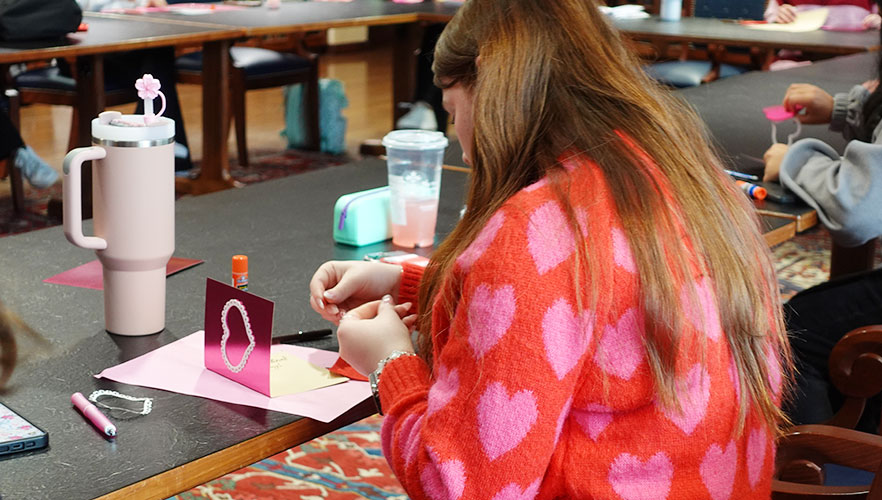 Student creating Valentine's Day card