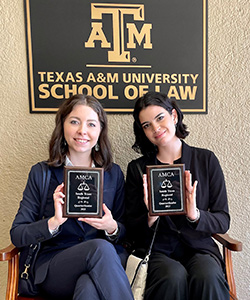 Holland and Goeke holding awards at A&M School of Law