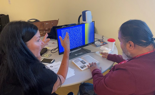 Man and woman sitting in front of computer