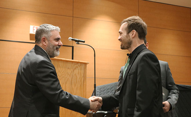 Rerick shaking hands with Dr. Clavere