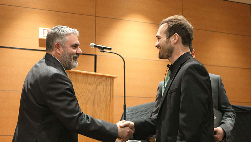 Rerick shaking hands with Dr. Clavere