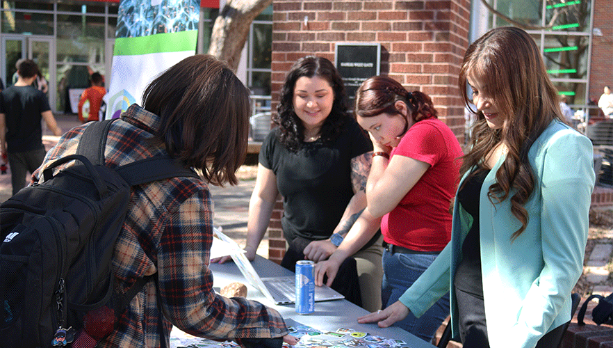 WiCyS members working event table