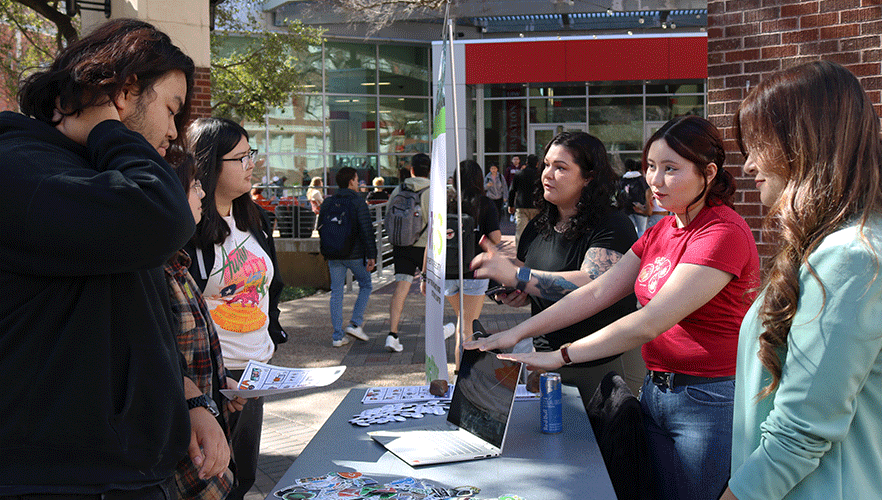 WiCyS members working event table.