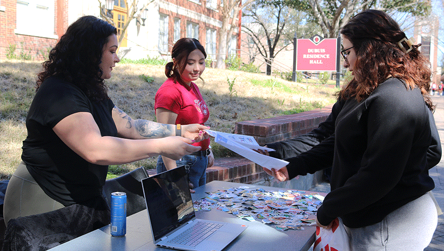 WiCyS members working event table.