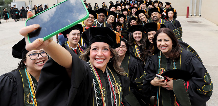 Spring 2025 graduates taking a selfie