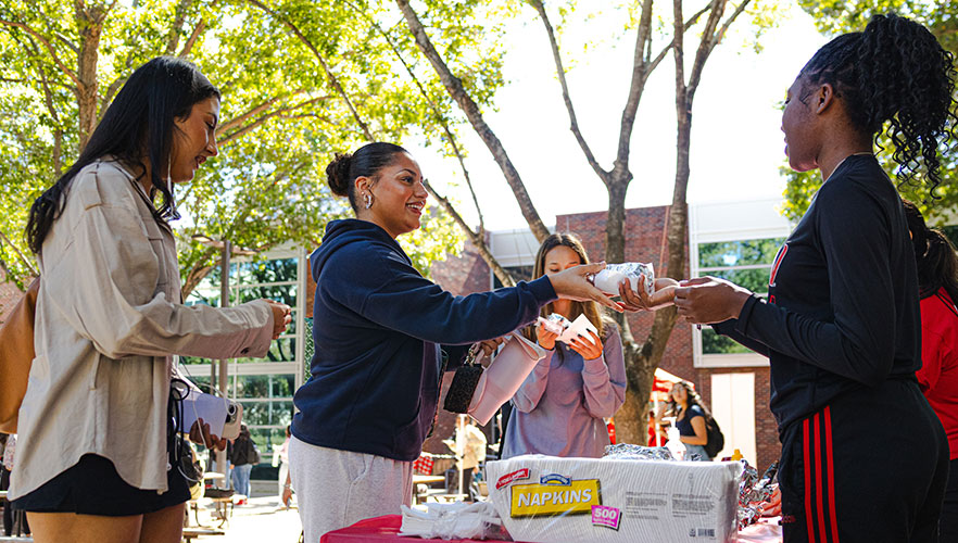 Attendees getting food