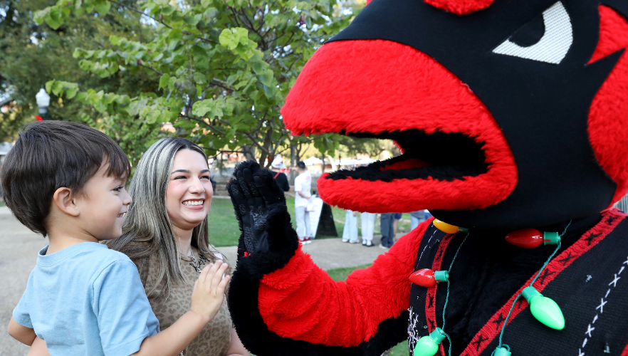 Kid smiling at Red the Cardinal