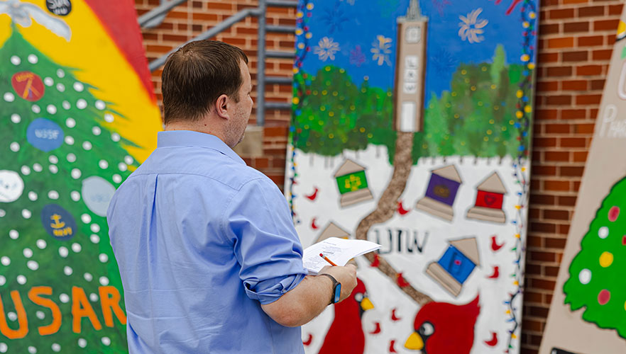 Eric Booth, dean of Campus Life, judging display boards