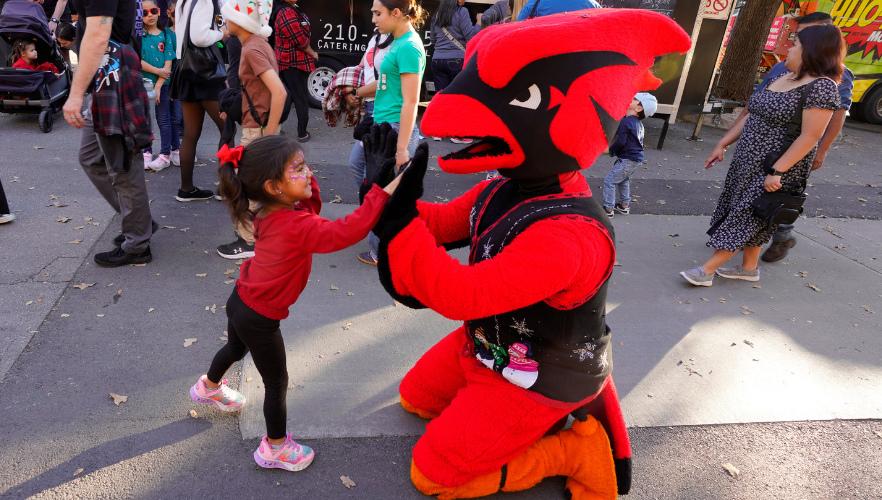 Red the Cardinal high-fiving kid
