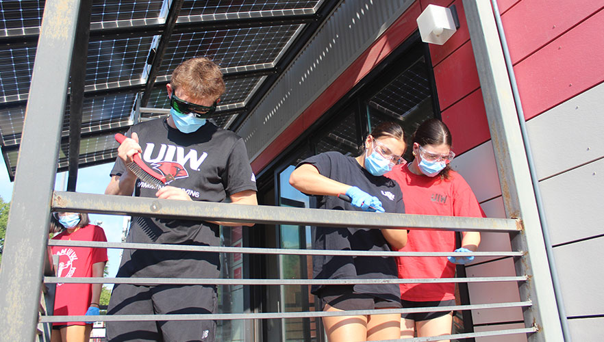 Students repainting Solar House