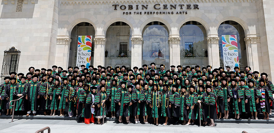Honored UIWSOM graduates in front of the Tobin Center