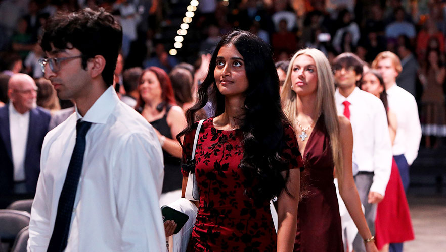 Students walking down aisle