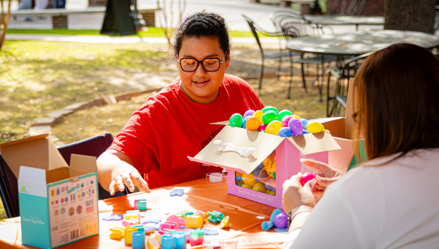 Student filling Easter eggs