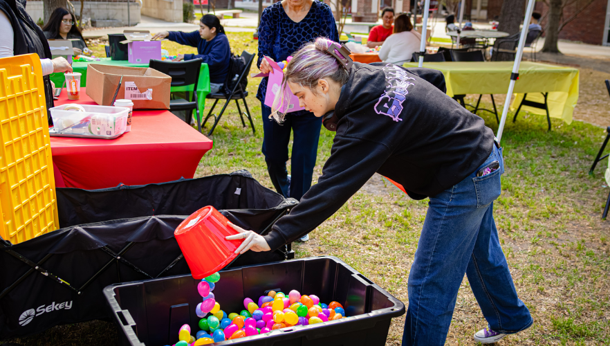 Student filling Easter eggs