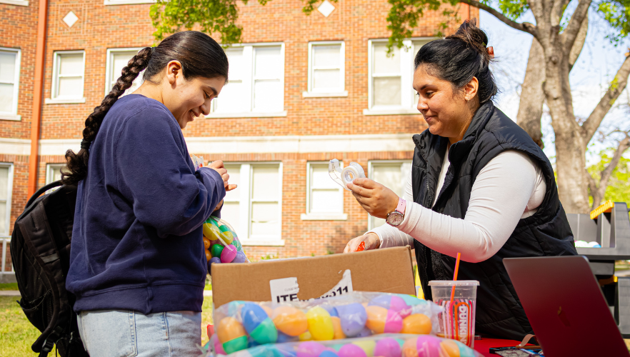 Student filling Easter eggs