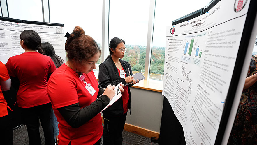 students looking at posters
