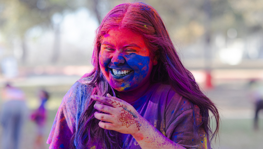 Student at Holi color throw
