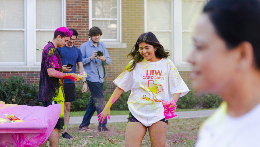 Student at Holi color throw