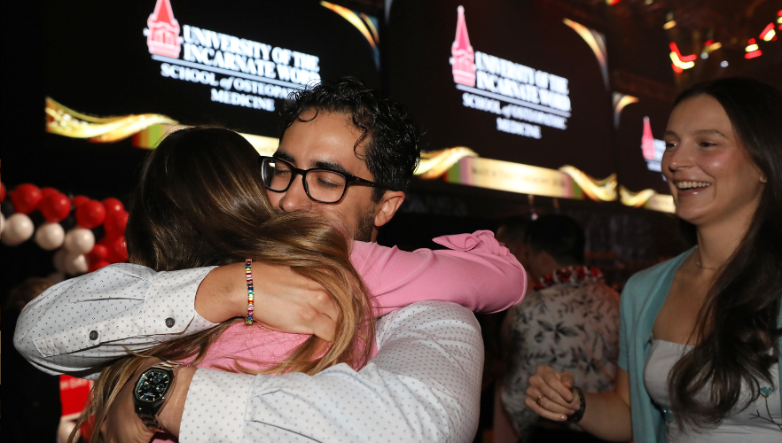 Medical student hugging loved one