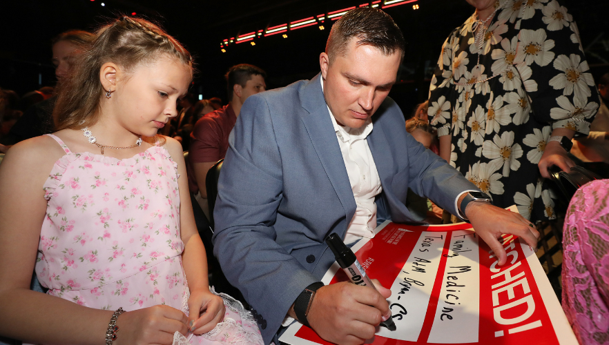 Medical student sharing results with daughter