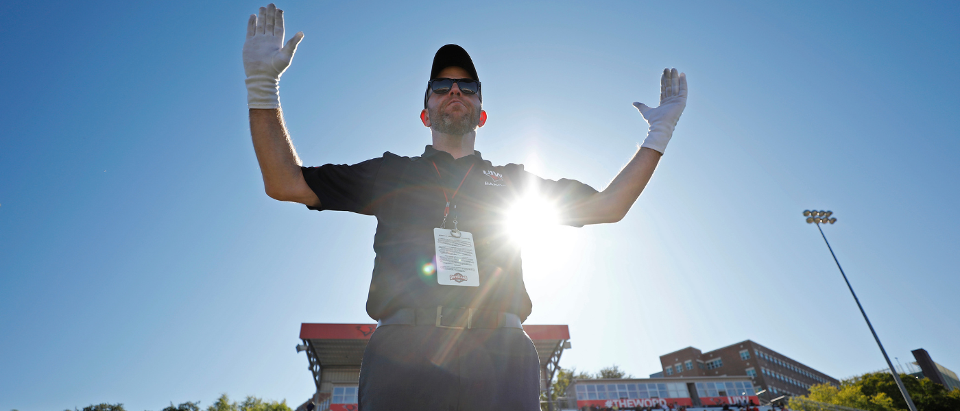 Dr. Brett Richardson conducting the UIW Marching Cardinals at a football game