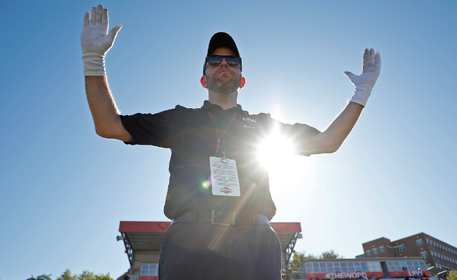 Dr. Brett Richardson conducting the UIW Marching Cardinals at a football game