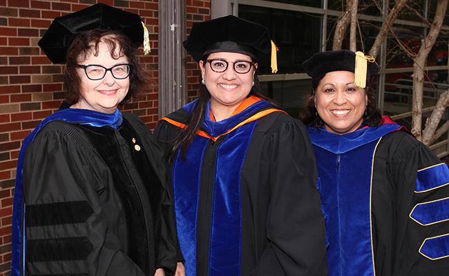 Three Faculty Members in celebratory garb