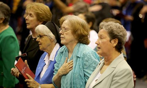 Women stand for the National Anthem