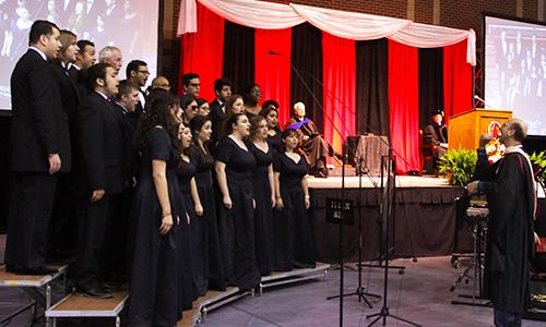 Professor William Gokelman directs UIW Cardinal Singers in singing the National Anthem