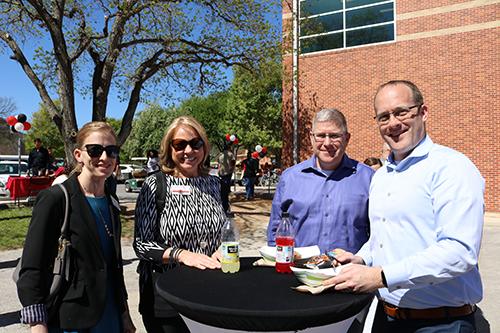 Four UIW Faculty members enjoying lunch at a table