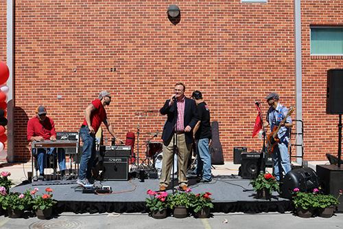 Dr. Evans gives a speech in front of a band