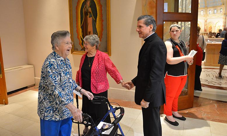 Archbishop Gustavo greets attendees