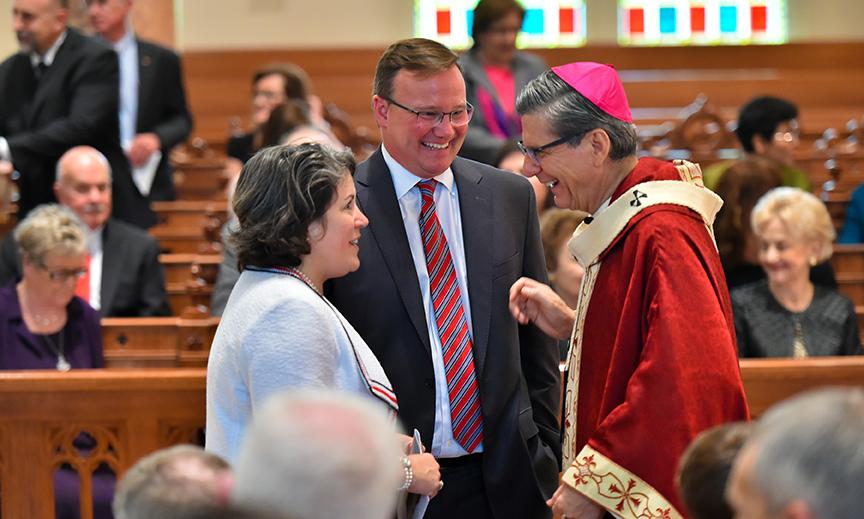 Archbishop Gustavo speaks with Dr. Evans and his wife