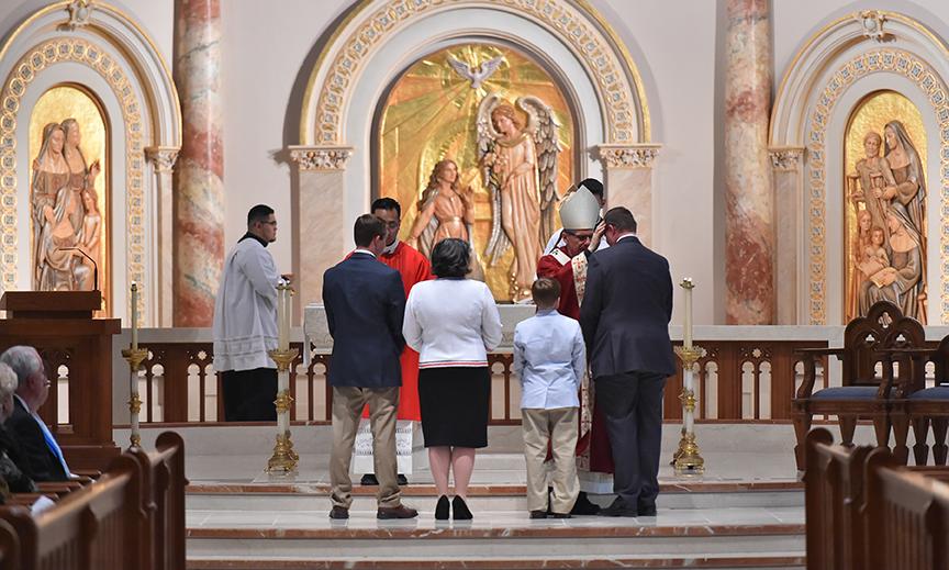 Archbishop Gustavo blesses Dr. Evans